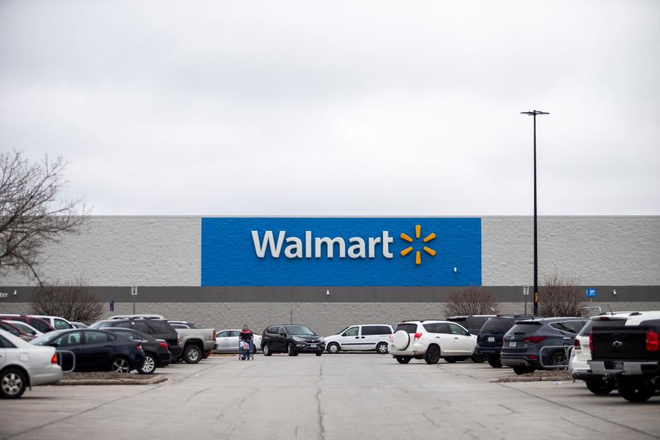 Cars fill the parking lot as shoppers come and go from Walmart on SE 14th Street, on Monday, March 23, 2020, in Des Moines. 