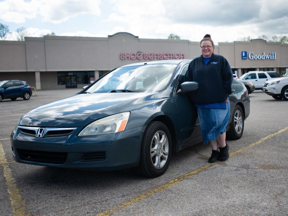 Katrina Newlin poses alongside inside her donated car from Goodwill's Wheels-to-work program in Lexington, Tenn., on Wednesday, April 3, 2024.