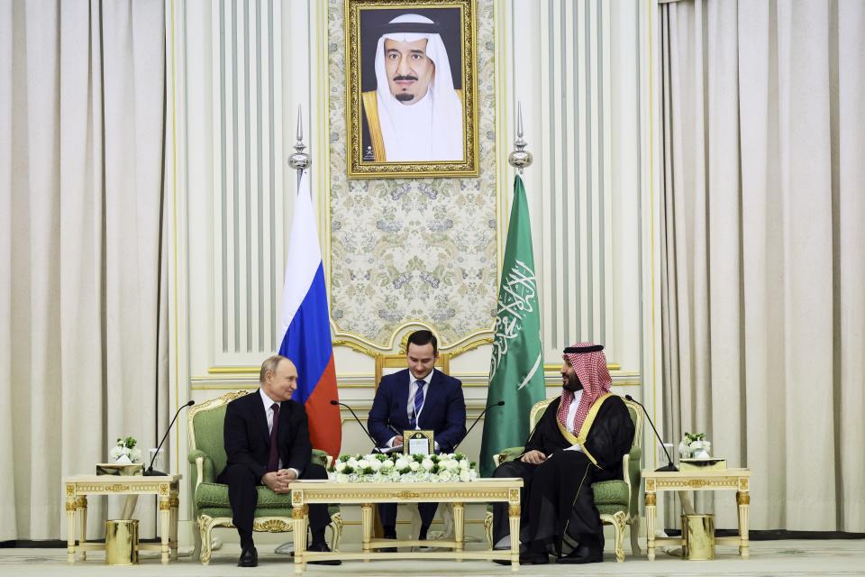 Saudi Crown Prince Mohammed bin Salman, right, and Russian President Vladimir Putin attend the talks at the Al Yamamah Palace in Riyadh, Saudi Arabia, on Wednesday, Dec. 6, 2023. At top a picture showing Saudi King Salman. (Sergei Savostyanov, Sputnik, Kremlin Pool Photo via AP)