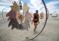 <p>Sandra Mallet views an art installation as approximately 70,000 people from all over the world gather for the 30th annual Burning Man arts and music festival in the Black Rock Desert of Nevada, Aug. 29, 2016. (REUTERS/Jim Urquhart)</p>