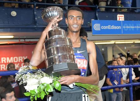 Feb 9, 2019; New York, NY, USA; Yomif Kejelcha (ETH) poses with trophy after winning the Wanamaker Mile in 3:48.46 - 0.01 off the world record of 3:48.45 set by Hicham El Guerrouj (MAR) in 1997 - during the 112th Millrose Games at The Armory. Mandatory Credit: Kirby Lee-USA TODAY Sports