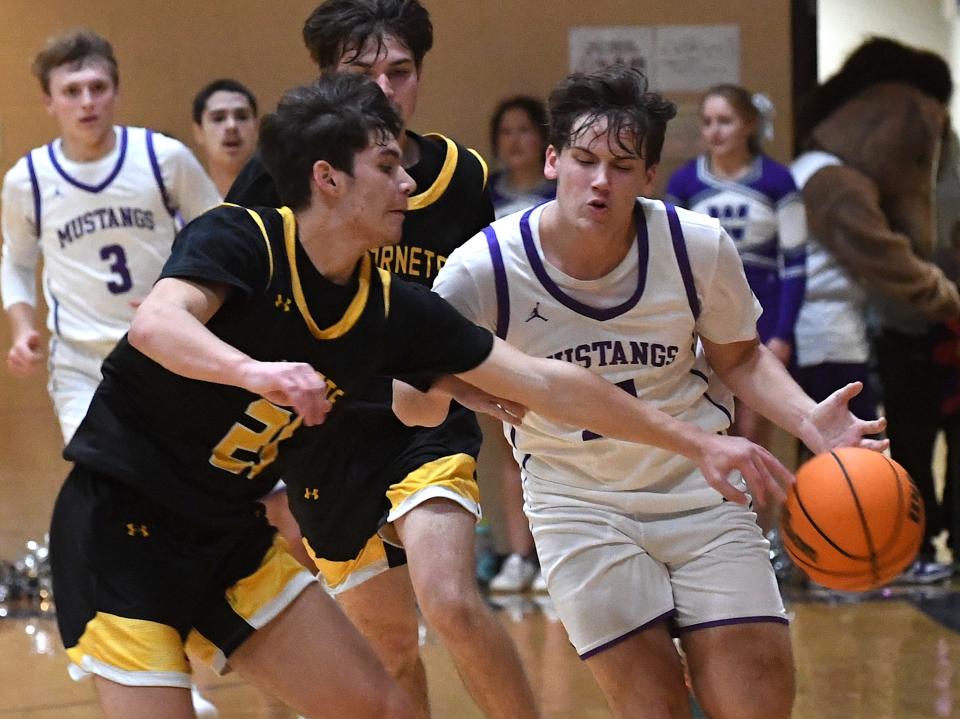 Copan High School's Teegan Caron (21) tries to steal the ball from Wesleyan Christian Mustang Cooper Holley (12) during basketball action in Bartlesville on Jan. 26, 2024.