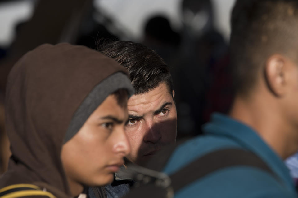 Migrants stand in line on the border bridge between Mexico and Guatemala, as they start applying for Mexican humanitarian visas at the port of entry to Ciudad Hidalgo, Chiapas state, Mexico, across the border from Tecun Uman, Guatemala, Monday, Jan. 21, 2019. Thousands of Central American migrants are waiting for Mexican officials to issue them humanitarian visas, which give them permission to be in Mexico for one year and work legally. (AP Photo/Moises Castillo)