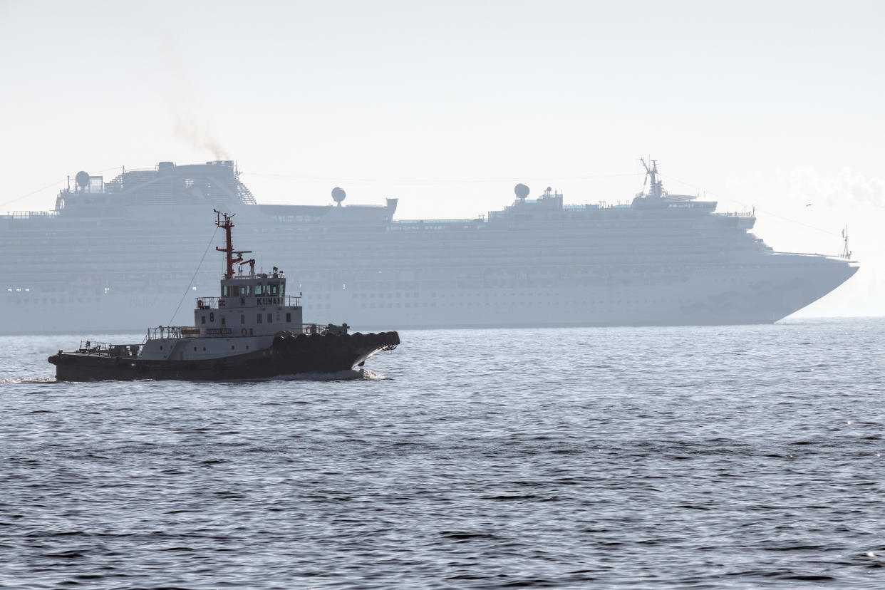 YOKOHAMA, JAPAN - FEBRUARY 05: A boat passes the Diamond Princess cruise ship with around 3,700 people on board as it sits anchored in quarantine off the port of Yokohama after a number of passengers were confirmed to be infected with coronavirus, on February 5, 2020 in Yokohama, Japan. 10 passengers are now believed to be infected with the coronavirus as Japanese authorities work to screen all people on board. The new cases bring the total number of confirmed infections to 33 in Japan. (Photo by Carl Court/Getty Images)