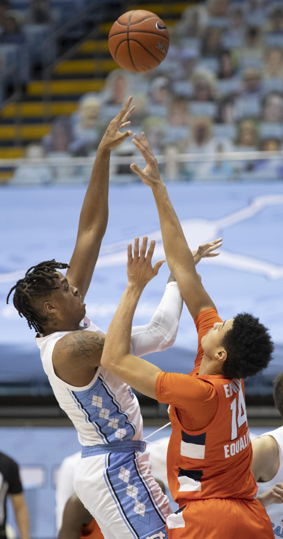 North Carolina's Armando Bacot, left, shoots against Syracuse's Jesse Edwards (14) during the first half of an NCAA college basketball game Tuesday, Jan. 12, 2021, in Chapel Hill, NC. (Robert Willett/The News & Observer via AP)