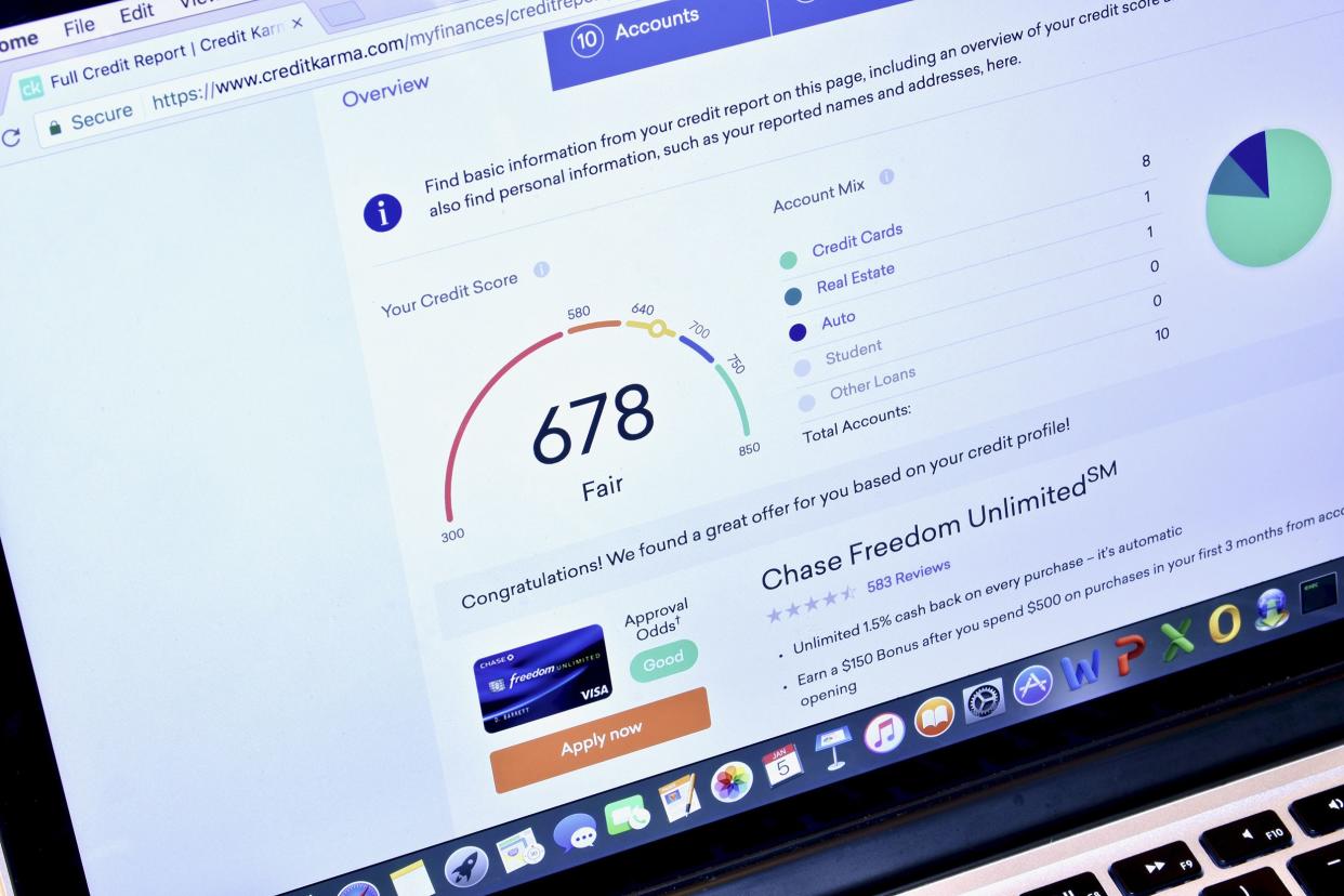 Macbook displaying the credit karma webpage with '678 fair' credit score and relevant information