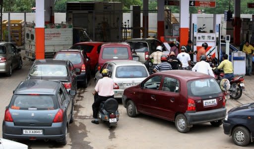 This file photo shows motorists lining up to get petrol and diesel at a filling station in New Delhi, in 2008. India's government is facing a growing backlash after hiking diesel 12 percent in a desperate bid to reverse its economic woes, as opponents say the move would stoke broader price rises