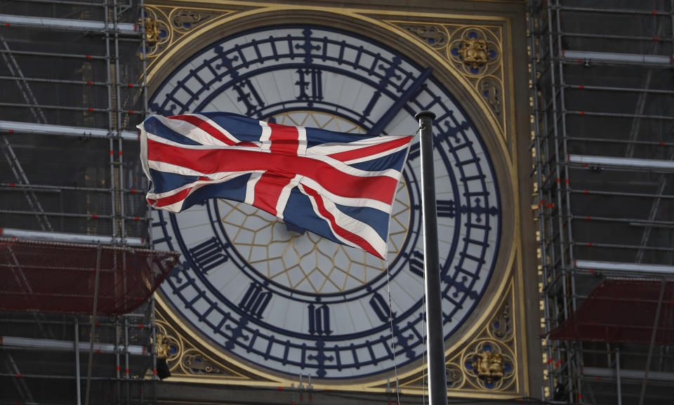 The Union flag of Great Britain and Northern Ireland flies in front of the clock face of the Queen Elizabeth Tower, that holds the bell known as 'Big Ben", part of the Houses of Parliament in London, Thursday, Oct. 10, 2019. Britain's Prime Minister Boris Johnson is to meet the Irish Prime Minister Leo Varadkar later Thursday for talks on Brexit. The Houses of parliament are undergoing restoration works. (AP Photo/Alastair Grant)