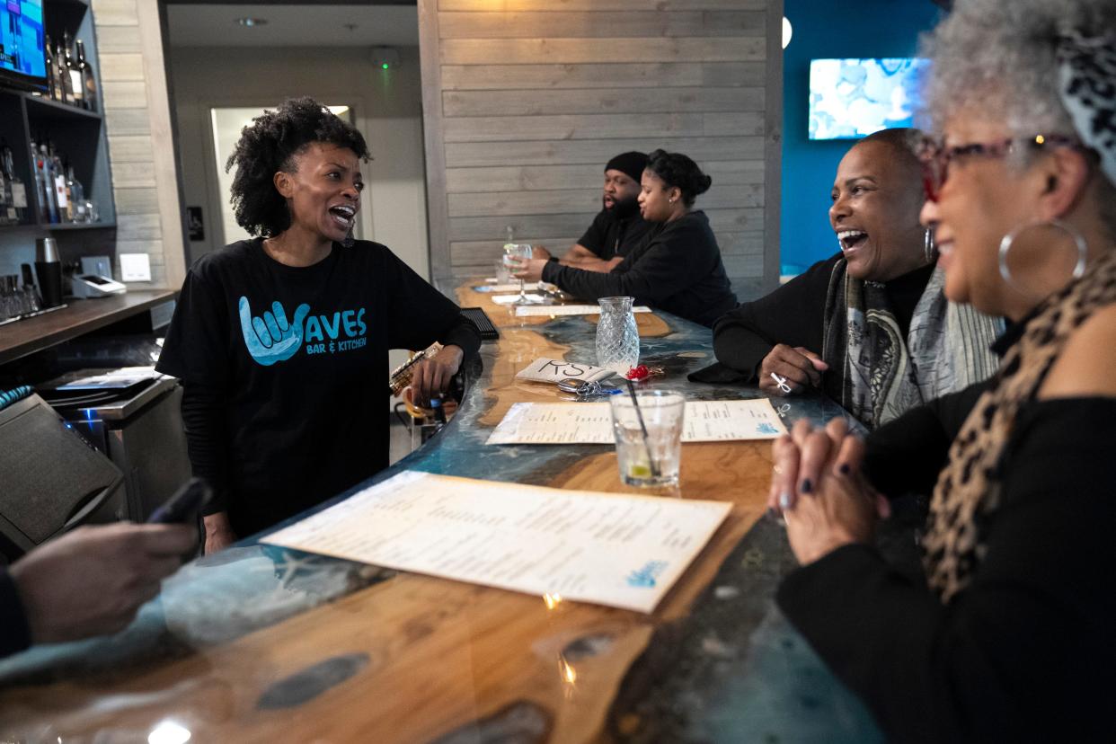 Jan 6, 2023; Columbus, Ohio, USA;  Tanitia Brown, a co-owner of Waves Bar, located in the King-Lincoln Bronzeville neighborhood of Columbus, laughs with Iris Nelms-Chatman, second from right, and Stephanie Harris on a Friday afternoon.
