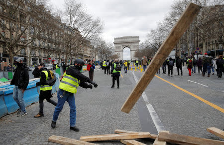 A protester wearing a yellow vest reacts during a demonstration by the "yellow vests" movement in Paris, France, March 16, 2019. REUTERS/Philippe Wojazer