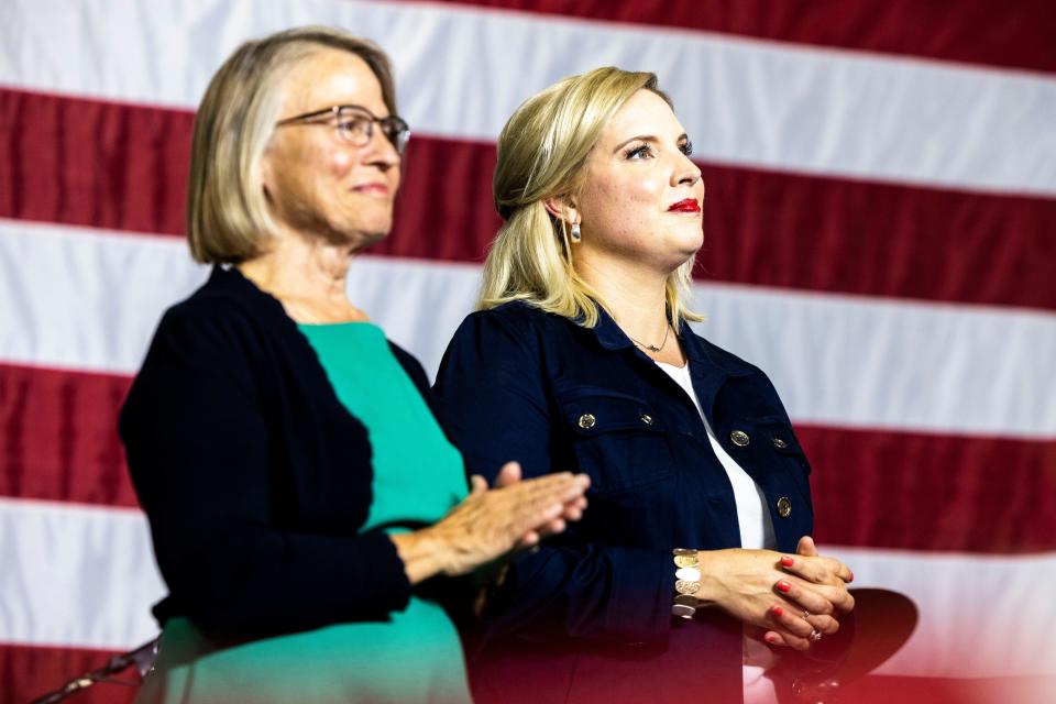 U.S. Rep. Mariannette Miller-Meeks, R-Iowa, left, and U.S. Rep. Ashley Hinson, R-Iowa, stand on stage during the Ashley's BBQ Bash fundraiser, Sunday, Aug. 6, 2023, at Hawkeye Downs in Cedar Rapids, Iowa.