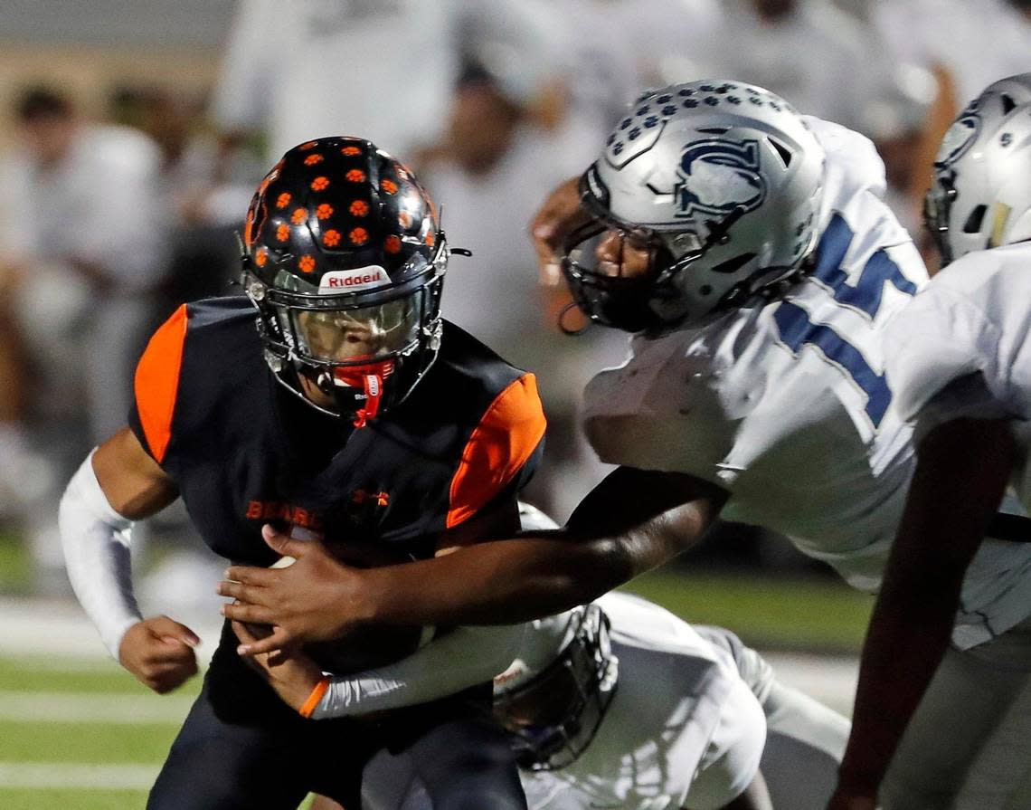 Shoemaker defensive end Zavian Tibbs (15) reaches in for Aledo running back Hawk Patrick-Daniels (1) in the first half of a Class 5A D1 bi-district football game between Killeen Shoemaker and Aledo at Bearcat Stadium in Aledo, Texas, Thursday, Nov. 10, 2022. Aledo led Shoemaker 28-0 at the half. (Special to the Star-Telegram Bob Booth)
