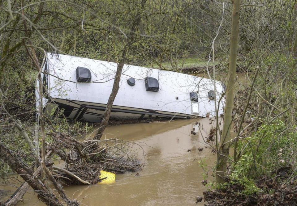 A recreational camper sits on its side in a creek near the town of Tornado, W. Va., on Friday, April 12, 2024, after record rainfall on Thursday. (Kenny Kemp/Charleston Gazette-Mail via AP)