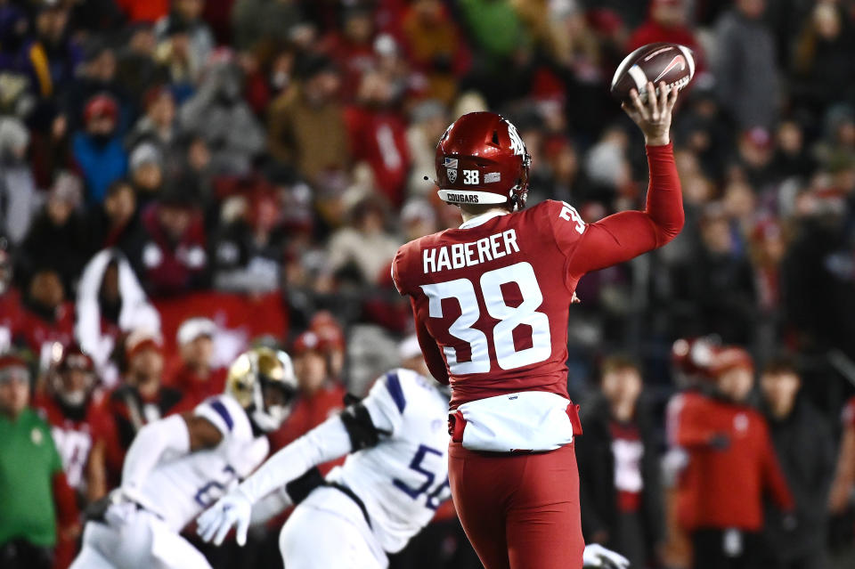 Nov 26, 2022; Pullman, Washington, USA; Washington State Cougars punter Nick Haberer (38) throws a pass for a first down against the Washington Huskies in first half at Gesa Field at Martin Stadium. Mandatory Credit: James Snook-USA TODAY Sports