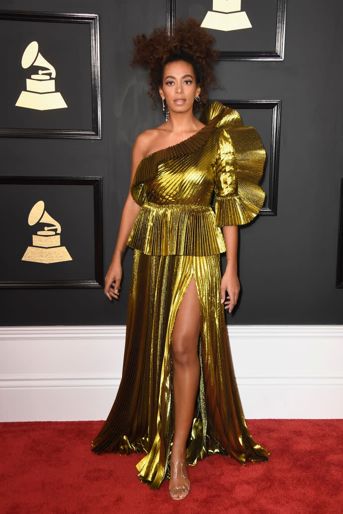 <p>SOlid gold from Solange! The singer won her first Grammy for Best R&B performance for “Cranes in the Sky,” and celebrated in this pleated, high-slit metallic gold gown. </p>