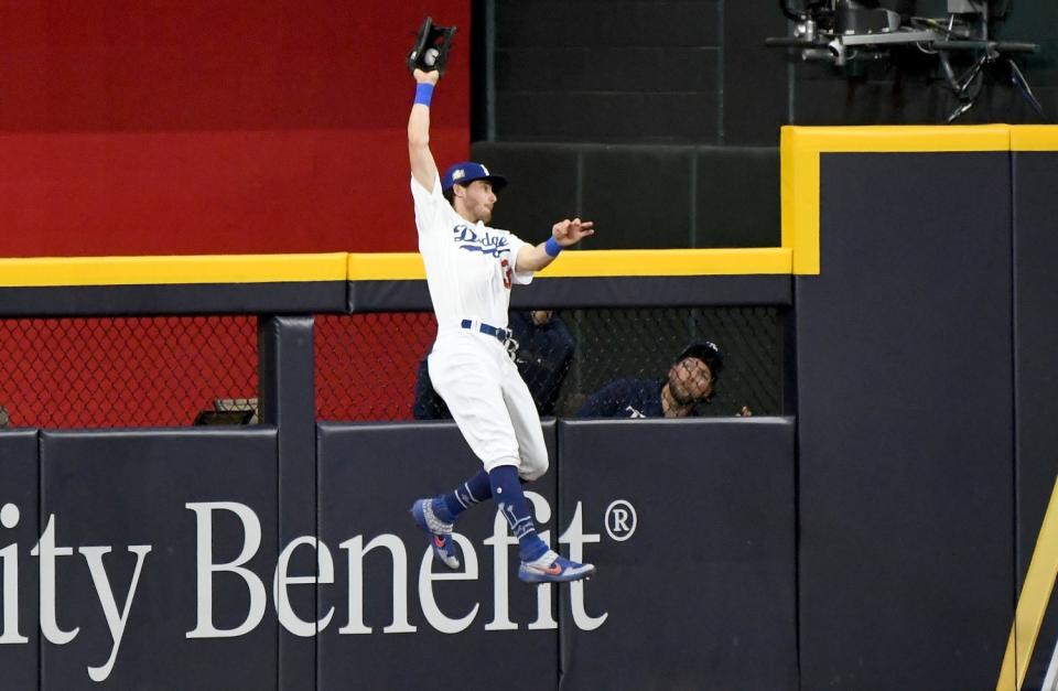 Dodgers center fielder Cody Bellinger makes a catch at the wall in the 9th inning in Game 1