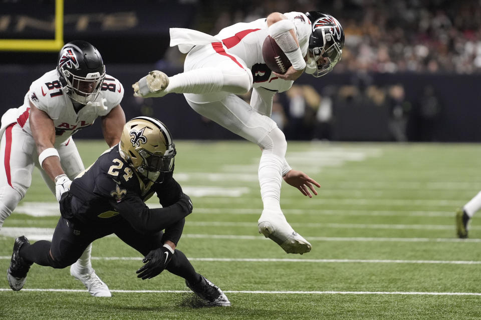 Atlanta Falcons quarterback Desmond Ridder (9) is tackled by New Orleans Saints safety Johnathan Abram (24) in the first half of an NFL football game in New Orleans, Sunday, Jan. 7, 2024. (AP Photo/Gerald Herbert)