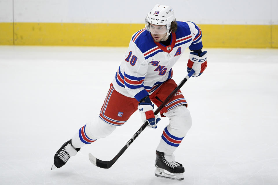 New York Rangers left wing Artemi Panarin (10) warms up before an NHL hockey game against the Washington Capitals in Washington, Saturday, Feb. 20, 2021. New York Rangers star Artemi Panarin is taking a leave of absence after a Russian tabloid printed allegations from a former coach that he attacked an 18-year-old woman in Latvia in 2011. Ex-NHL enforcer Andrei Nazarov is the source for the report after coaching Panarin in the Kontinental Hockey League. Nazarov says he was motivated to speak about it because he disagreed with Panarin’s repeated criticism of the Russian government. Panarin denied the allegations in a statement released by the Rangers. (AP Photo/Nick Wass, File)