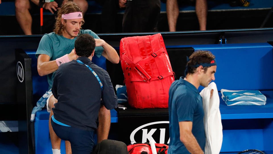 Stefanos Tsitsipas receives medical attention. (Photo by DAVID GRAY/AFP/Getty Images)