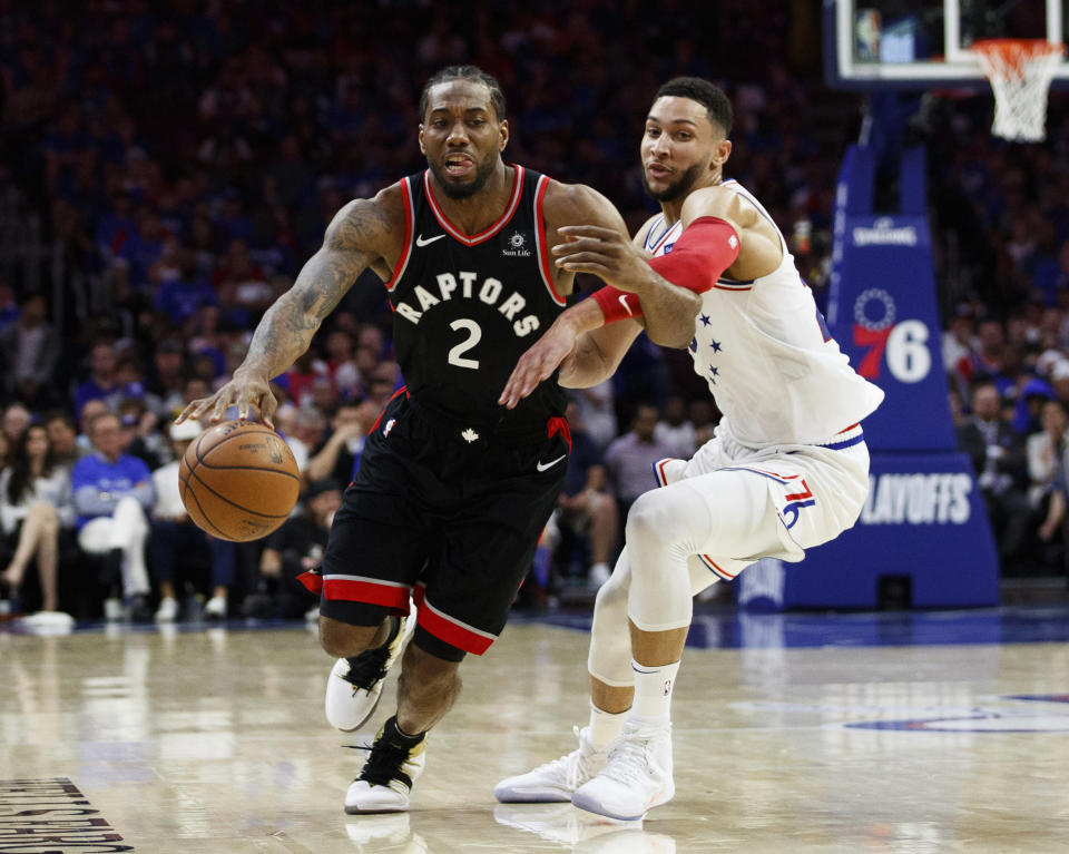 Toronto Raptors' Kawhi Leonard moves around Philadelphia 76ers' Ben Simmons, right, during the first half of Game 3 of a second-round NBA basketball playoff series Thursday, May 2, 2019, in Philadelphia. The 76ers won 116-95. (AP Photo/Chris Szagola)