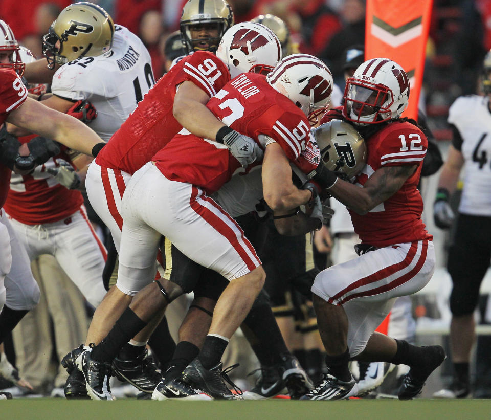 MADISON, WI - NOVEMBER 05: Raheem Mostert #8 of the Purdue Boilermakers is gang-tackled by Dezmen Southward #12, Mike Taylor #53 and Jordan Kohout #91 of the Wisconsin Badgers at Camp Randall Stadium on November 5, 2011 in Madison Wisconsin. Wisconsin defeated Purdue 62-17. (Photo by Jonathan Daniel/Getty Images)