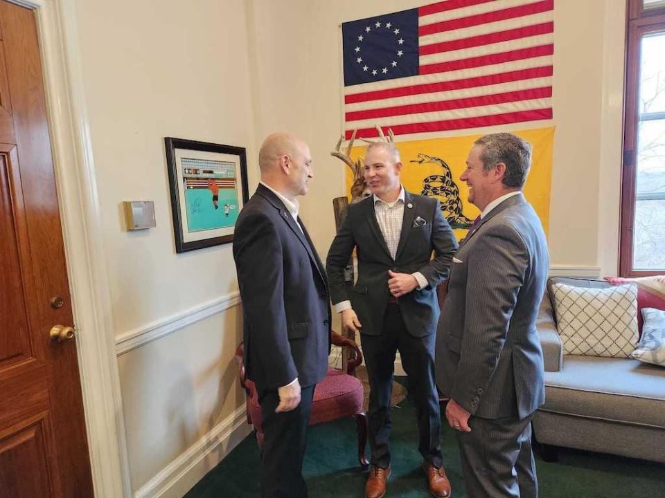 Missouri state Sens. Denny Hoskins, left, and Rick Brattin, center, confer with Freedom Caucus Director Tim Jones, right. Hoskins and Brattin are Republicans and members of the State Freedom Caucus Network, which aims to push the party further to the right.