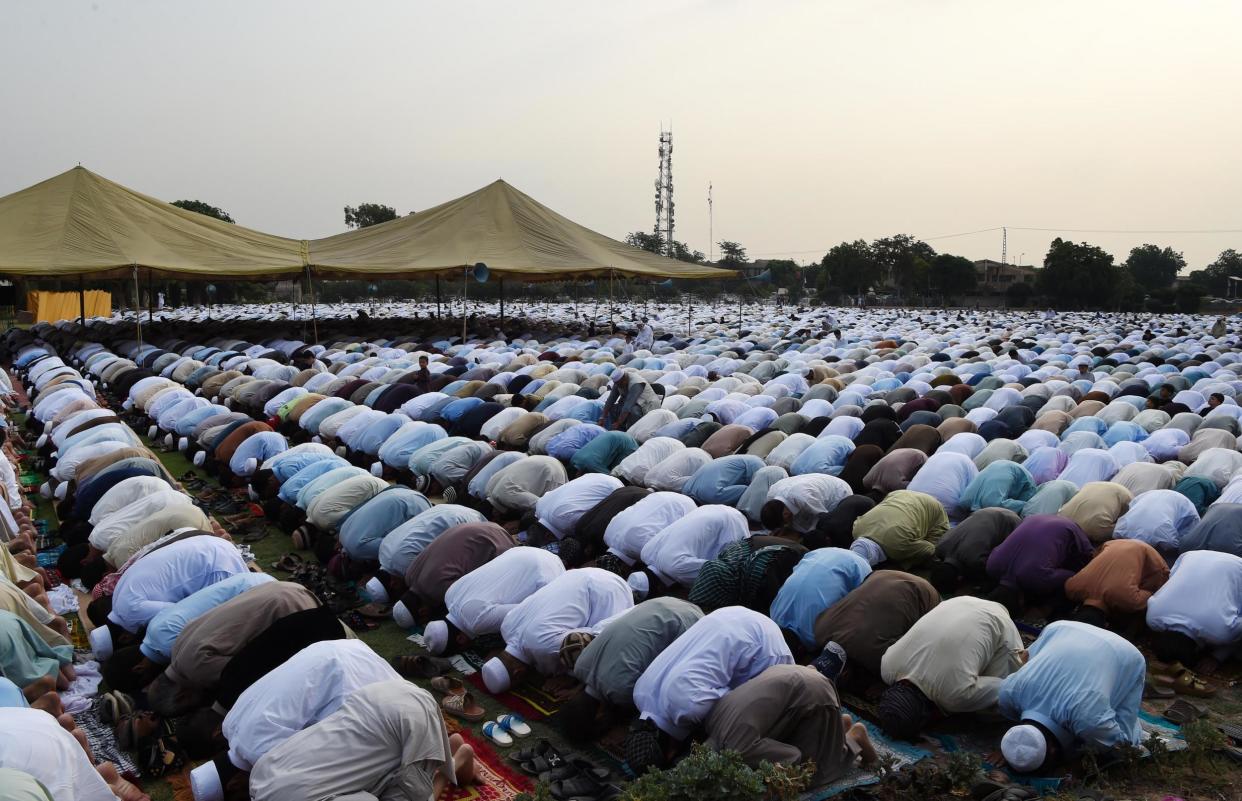 Pakistani residents offer Eid al-Fitr prayers on the outskirts of Peshawar: AFP/Getty Images