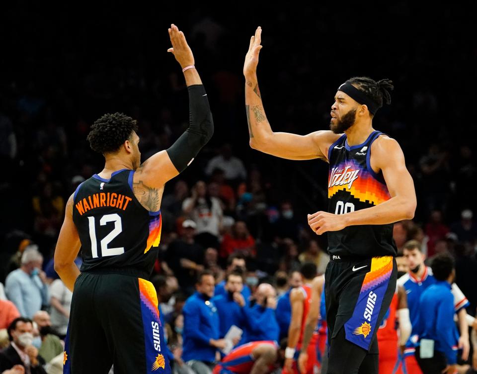 Dec 2, 2021; Phoenix, Arizona, USA; Phoenix Suns forward Ish Wainright (12) high-fives center JaVale McGee (00) during a time out against the Detroit Pistons at Footprint Center. Mandatory Credit: Rob Schumacher-Arizona Republic