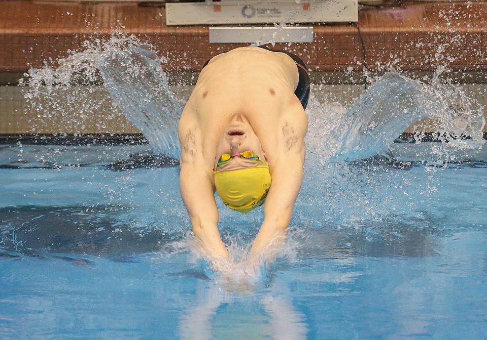Firestone senior Jonny Marshall dives in for the start of the 100-yard backstroke in the Division I district meet Saturday, Feb. 18, 2023 at Cleveland State.