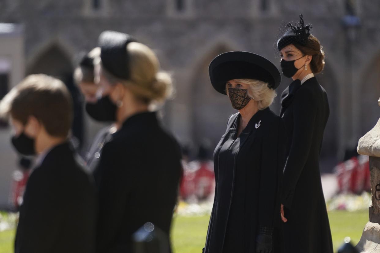 Camilla, the Duchess of Cornwall, second right and Kate, the Duchess of Cambridge stand outside of St George's Chapel ahead of Britain Prince Philip's funeral at Windsor Castle, Windsor, England, Saturday April 17, 2021.