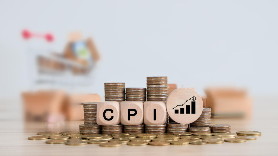 CPI, consumer price index concept. Wooden block with the words CPI on coins stack. Goods price inflation and inflation rising. Impact on economic growth with relate icon.