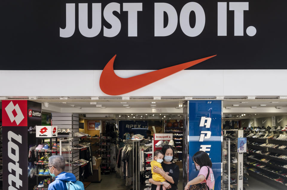 HONG KONG, CHINA - 2020/08/28: Pedestrians wearing masks walk past American multinational sport clothing brand Nike store, logo, with a slogan "Just Do It"  in Hong Kong. (Photo by Budrul Chukrut/SOPA Images/LightRocket via Getty Images)