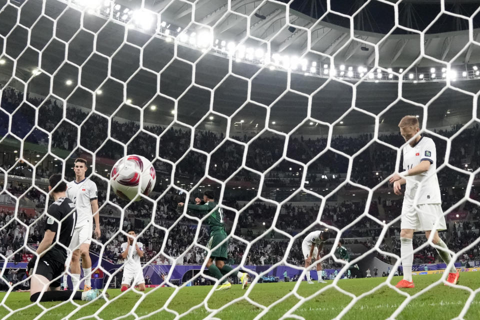 Kyrgyzstan players react after the second goal of Saudi Arabia during the Asian Cup Group F soccer match between Kyrgyzstan and Saudi Arabia at Ahmad Bin Ali Stadium, in Doha, Qatar, Sunday, Jan. 21, 2024. Saudi Arabia won 2-0. (AP Photo/Aijaz Rahi)