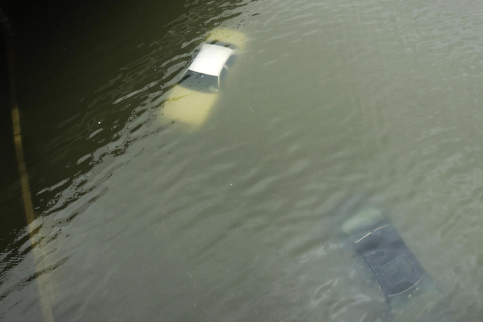 FILE - Cars are submerged on a freeway flooded in the aftermath of Hurricane Harvey near downtown Houston, Texas, on Aug. 27, 2017. Hurricanes in the U.S. over last few decades killed thousands more people than meteorologists traditionally calculate and a disproportionate number of those victims are poor, vulnerable and minorities, according to a new epidemiological study released Wednesday, Aug. 16, 2023. (AP Photo/Charlie Riedel, File)