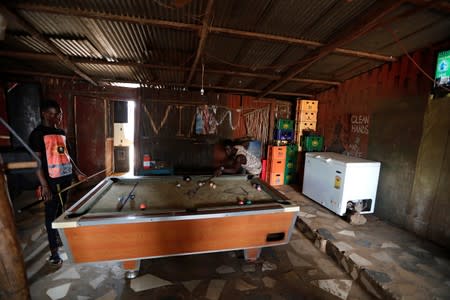 Men play pool at the bar belonging to gold trader and informal miner Stephen 'Rasta' Ble at the mining site of Nsuaem-Top