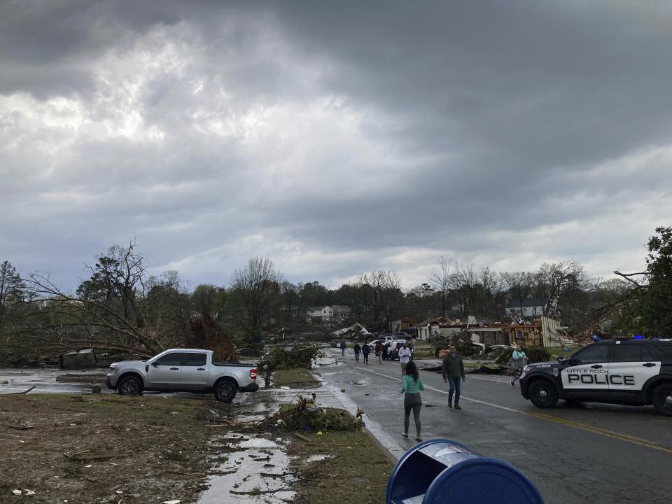 Residents mill about after severe storm swept through Little Rock, Ark., Friday, March 31, 2023. (AP Photo/Andrew DeMillo)