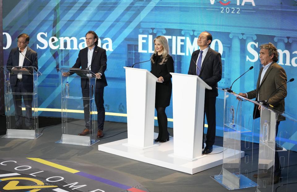 Presidential candidate Gustavo Petro of the Historical Pact coalition, left, Federico Gutierrez, presidential candidate representing the Team for Colombia coalition, second left, and Hope Coalition presidential candidate Sergio Fajardo, right, take part in a presidential debate at the El Tiempo newspaper in Bogota, Colombia, Monday, May 23, 2022, ahead of the first round May 29th elections. (AP Photo/Fernando Vergara)