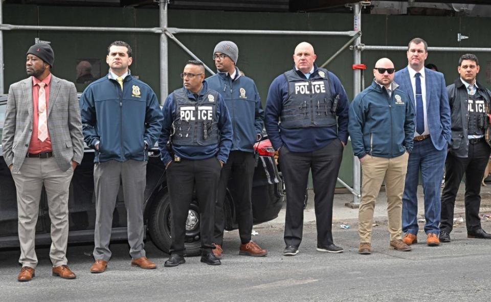 NYPD officers line up to watch Jones walk out of the station house after being arrested. Gregory P. Mango