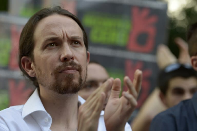 Leader of the Podemos political party, Pablo Iglesias, claps as he takes part in a demonstration in Madrid on June 27, 2015