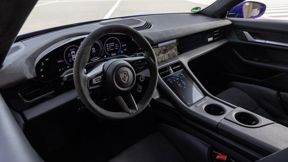 The steering wheel and dashboard in a 2025 Porsche Taycan Turbo GT.