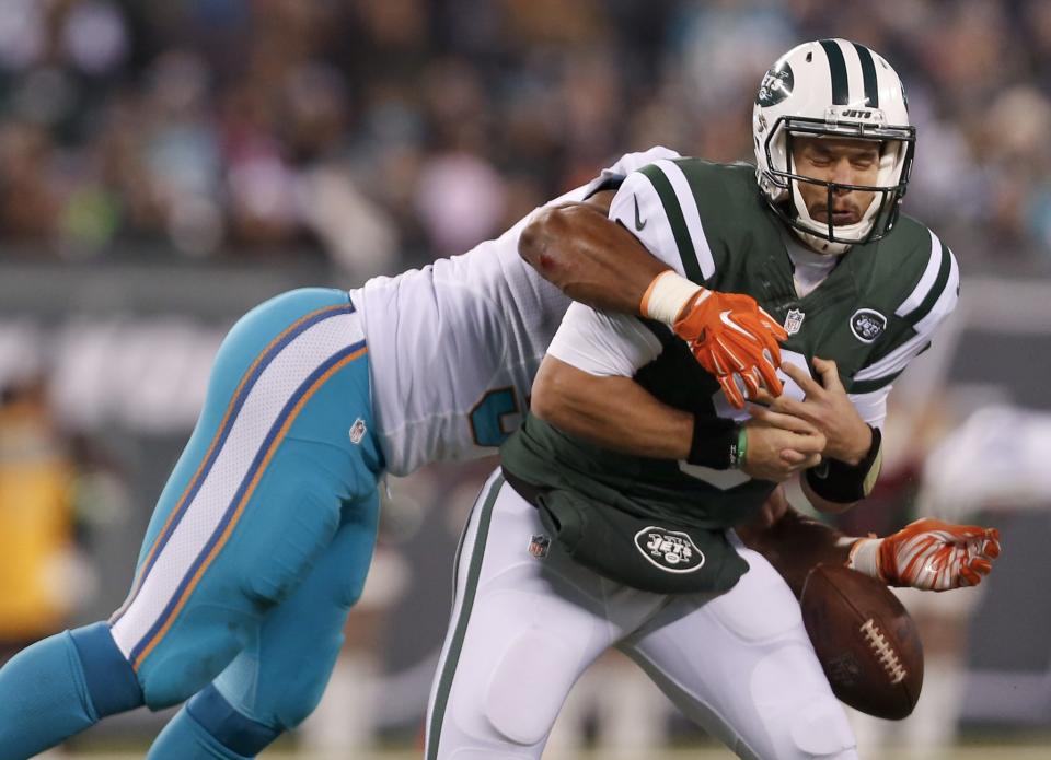 Miami Dolphins pass rusher Cameron Wake, left, crushes New York Jets QB Bryce Petty on Saturday. (AP)