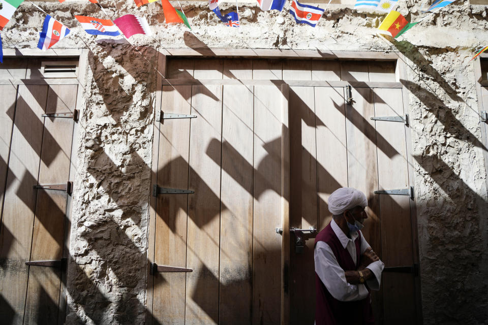 A porter waits for customers at the Souq Waqif Market in Doha, Qatar, Tuesday, Nov. 29, 2022. (AP Photo/Eugene Hoshiko)