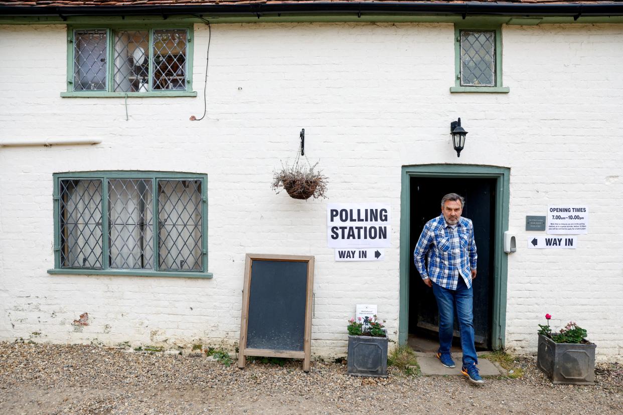 A man walks out of The Brocket Arms pub which is acting as a polling station for local elections in Ayot St Lawrence, Britain, May 4, 2023 (REUTERS)