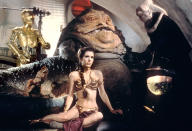 <p>“Slave Leia” came into the pop culture vernacular when Fisher donned that famous gold bikini as the captive of Jabba the Hutt in the third film in George Lucas’s original ‘Star Wars’ trilogy. (Photo: Everett Collection) </p>