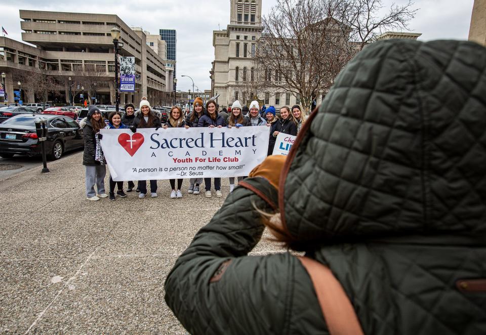 Members of the Sacred Heart Academy Youth For Life Club had their photo taken as they held up a sign near the steps of Louisville Metro Hall. Right to Life of Louisville hosted the rally to commemorate the 49th anniversary of Roe v Wade. January 21, 2022