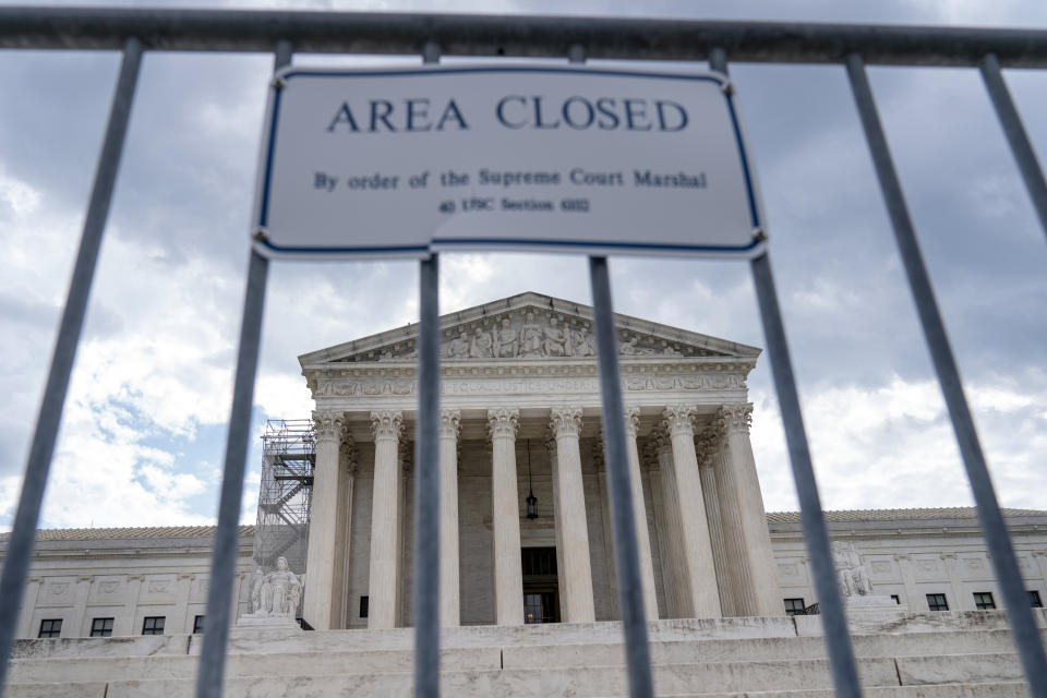 The Supreme Court is seen behind security fencing, Tuesday, June 27, 2023, in Washington, as decisions are expected. (AP Photo/Jacquelyn Martin)