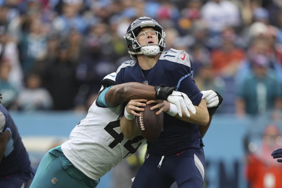 Jacksonville Jaguars linebacker Travon Walker (44) sacks and causes a fumble of Tennessee Titans quarterback Ryan Tannehill (17) during an NFL football game, Sunday, Dec. 11, 2022, in Nashville, Tenn. (AP Photo/Peter Joneleit)