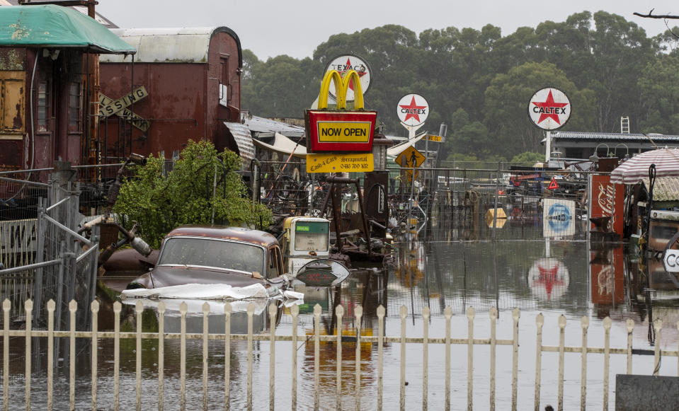 Equipment lies partly submerged at a property in Londonderry on the outskirts of Sydney, Australia, Tuesday, March 23, 2021. Hundreds of people have been rescued from floodwaters that have isolated dozens of towns in Australia's most populous state of New South Wales and forced thousands to evacuate their homes as record rain continues to inundate the countries east coast. (AP Photo/Mark Baker)