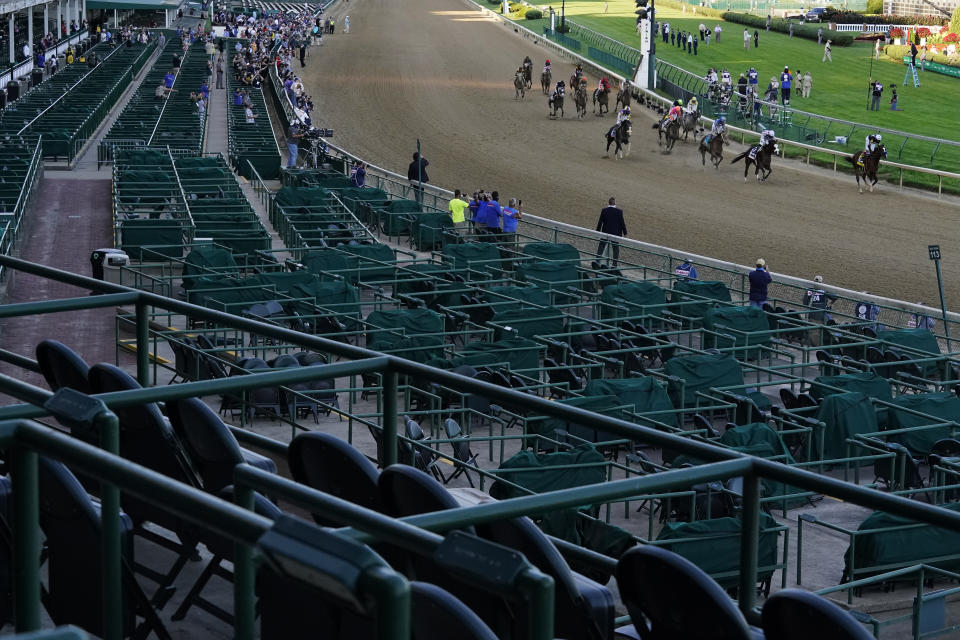 FILE - Jockey John Velazquez riding Authentic, right, leads the field after winning the 146th running of the Kentucky Derby at Churchill Downs in Louisville, Ky., Sept. 5, 2020. The Derby has survived two world wars, the Great Depression, and pandemics, including COVID-19 in 2020, when it ran in virtual silence without the usual crowd of 150,000. (AP Photo/Charlie Riedel, File)