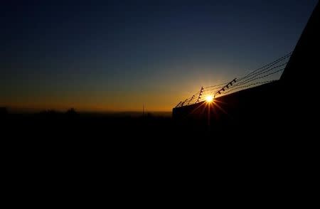 Barbed wire is seen on the wall of the former concentration camp in Mauthausen, Austria, November 29, 2016. REUTERS/Leonhard Foeger/Files